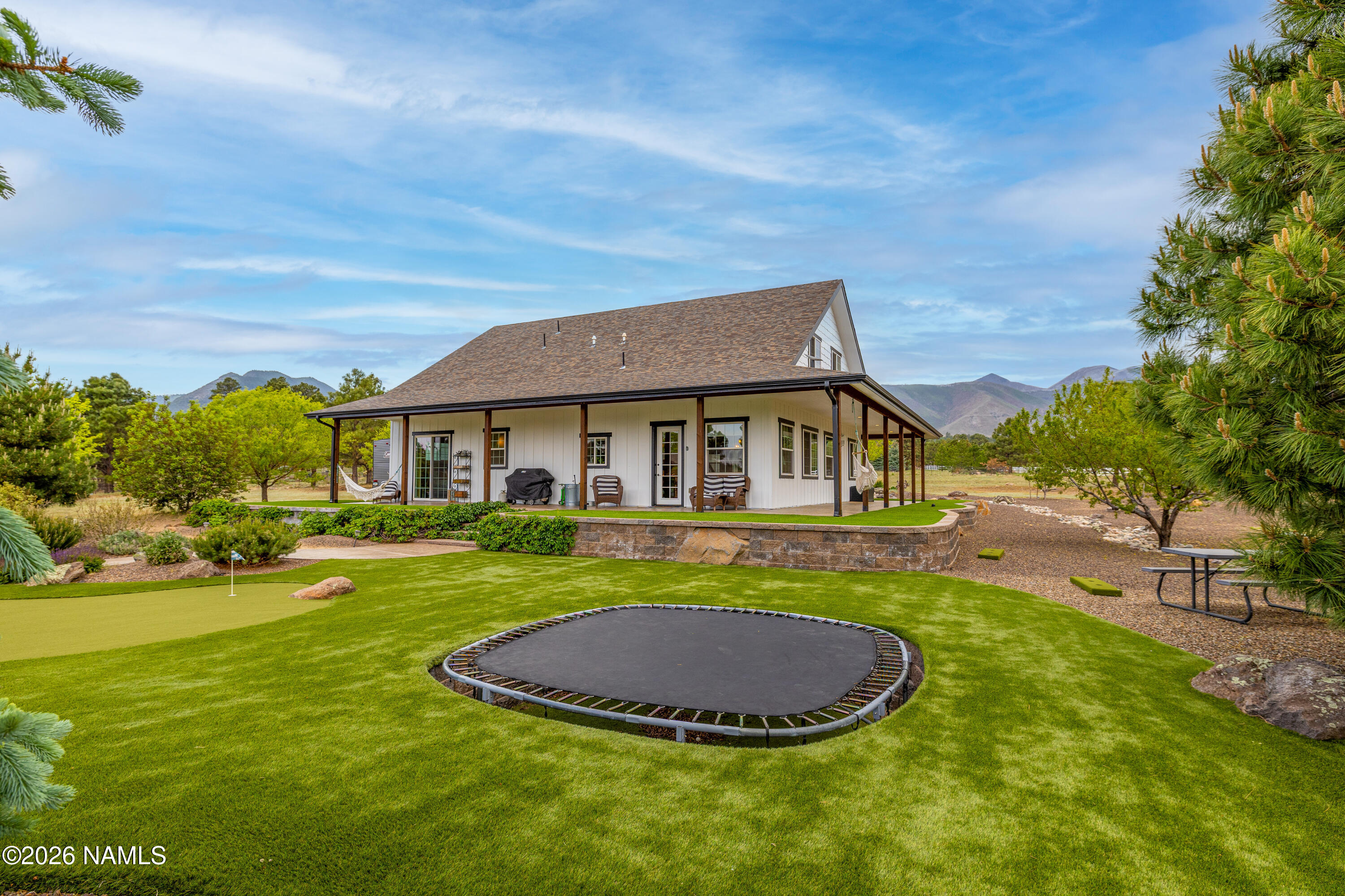 10833 Sage Road Flagstaff, AZ 86004 - Photo 38 of 45 a front view of a house with a yard table and chairs