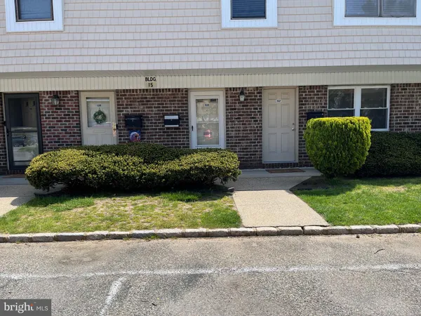 a view of a house with a small yard and a garage