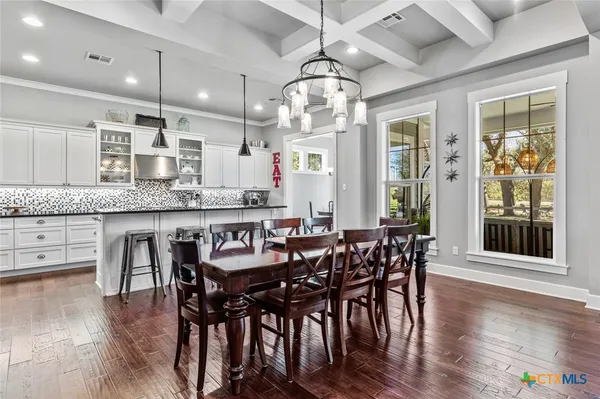 a large kitchen with a table and chairs