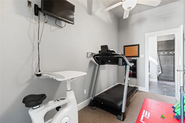 a room with gym equipment and view of living room