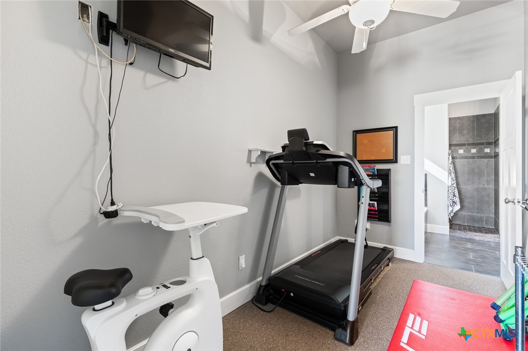 8355 Poison Oak Road, Unit H Temple, TX 76502 - Photo 26 of 48 a room with gym equipment and view of living room