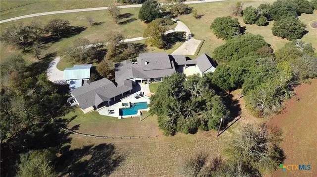 an aerial view of a house with a yard