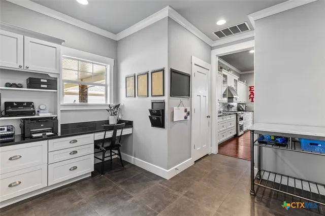 a kitchen with stainless steel appliances a refrigerator and cabinets