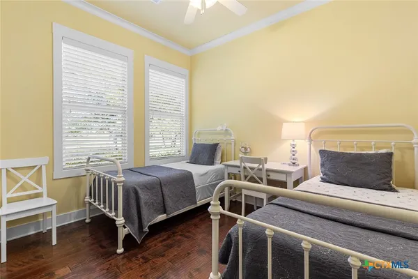 a bedroom with 2 bed and a window