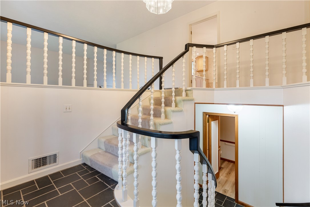 2240 Devonshire Road Northwest Canton, OH 44708 - Photo 2 of 36 Step inside to the tile foyer with decorative banister and chandelier.