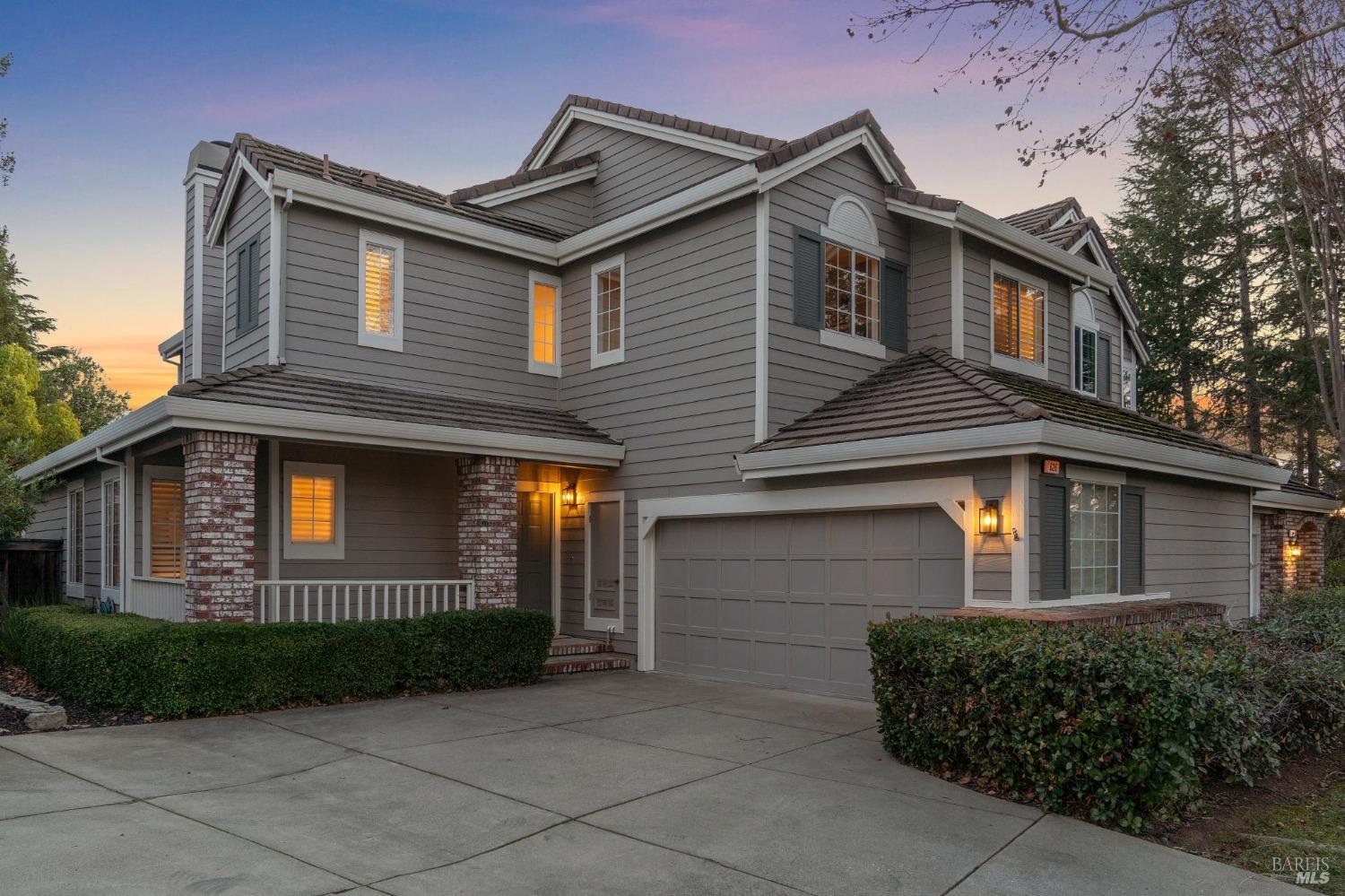 a front view of a house with a garden