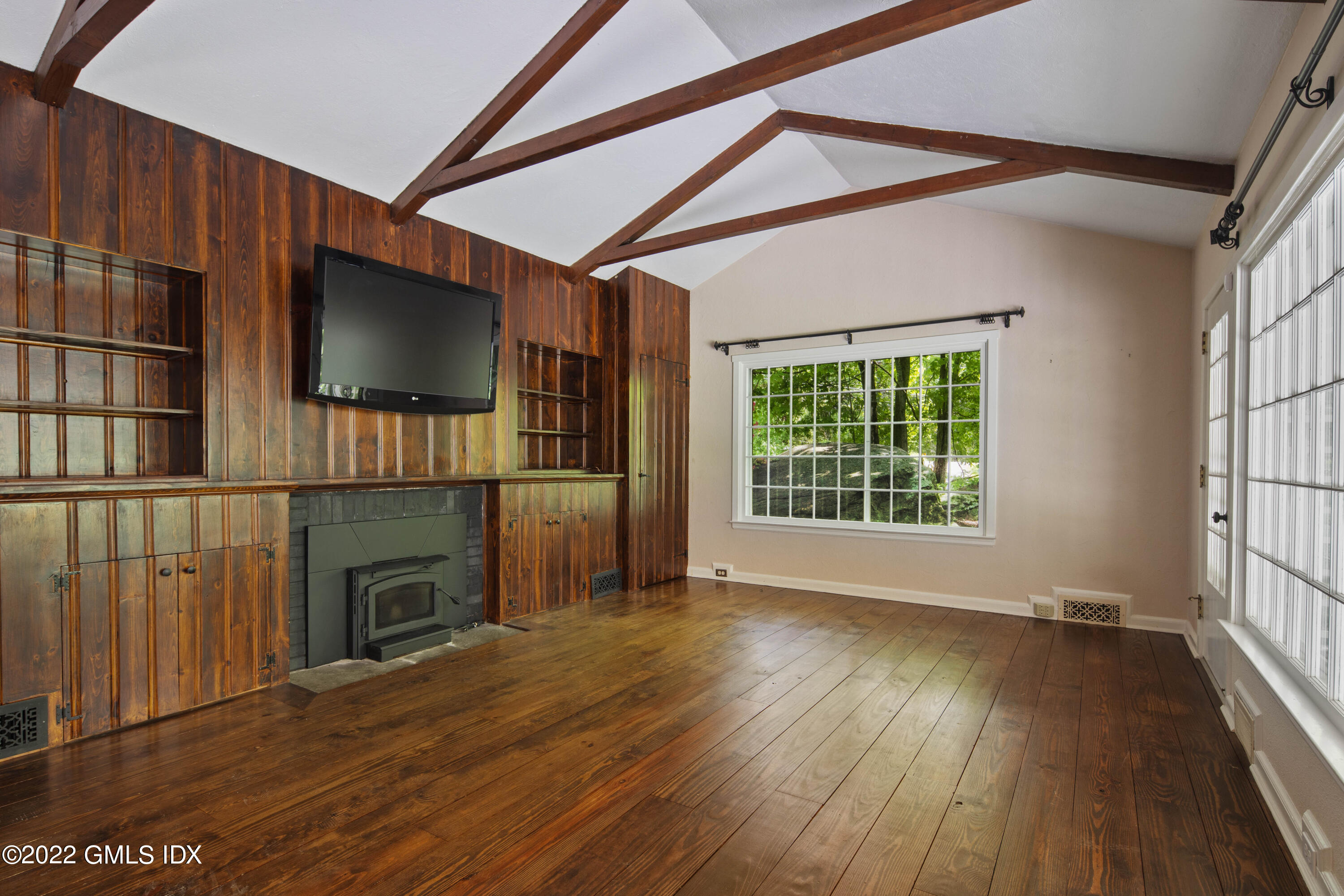 324 Haviland Road Stamford, CT 06903 - Photo 11 of 40 a view of empty room with wooden floor and fireplace