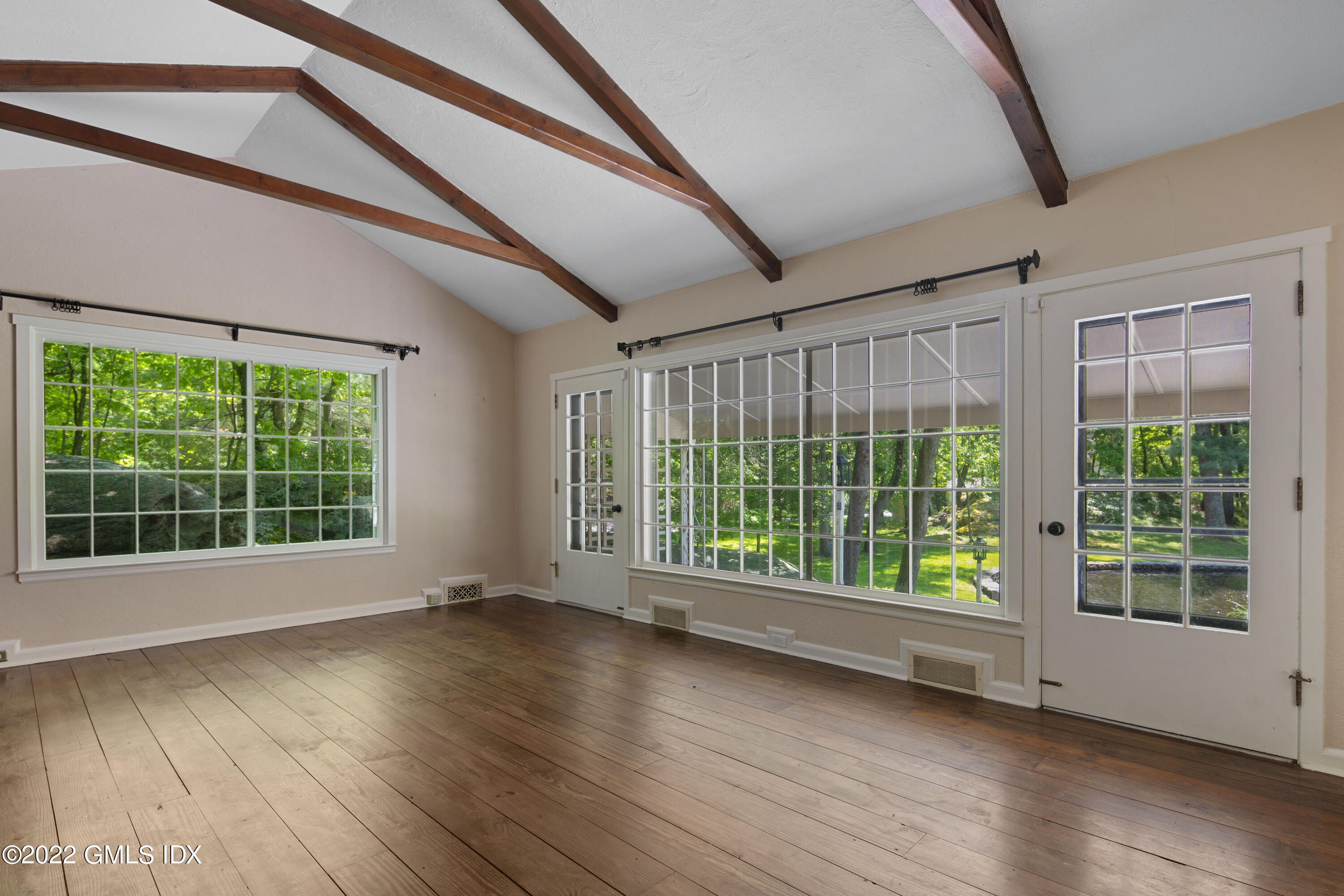 324 Haviland Road Stamford, CT 06903 - Photo 12 of 40 a view of an empty room with wooden floor and a window