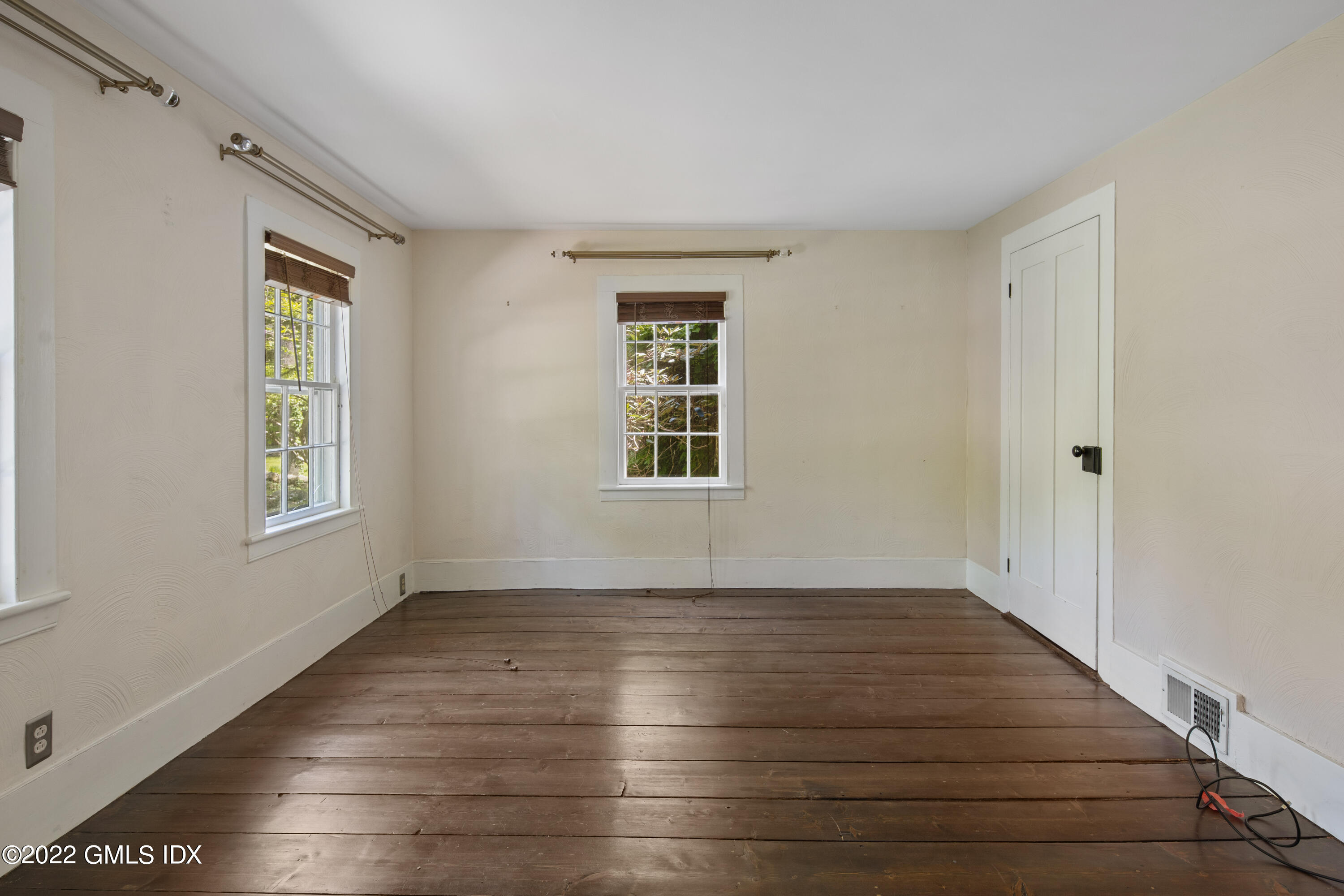 324 Haviland Road Stamford, CT 06903 - Photo 14 of 40 a view of an empty room with wooden floor and a window