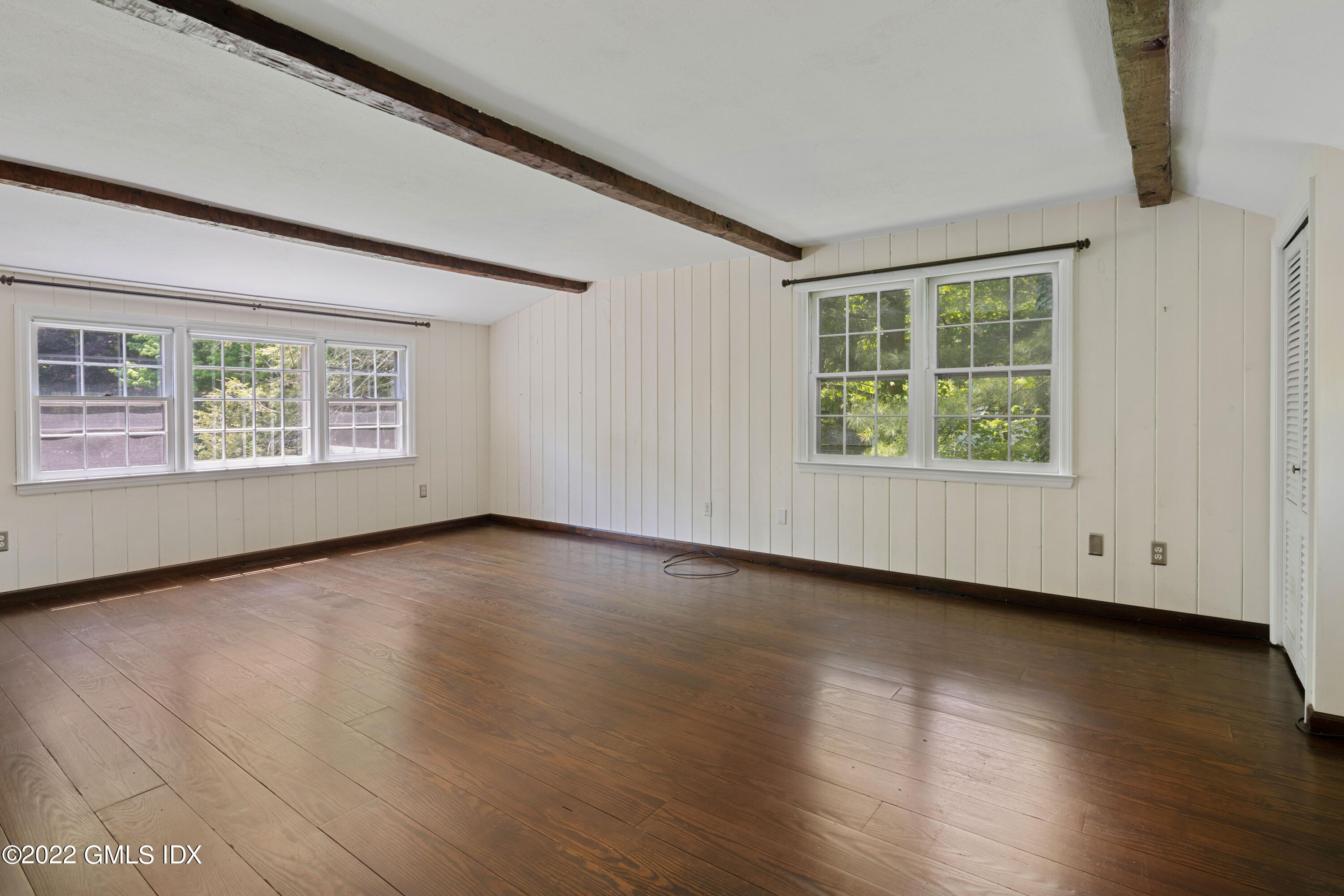 324 Haviland Road Stamford, CT 06903 - Photo 17 of 40 an empty room with wooden floor and windows