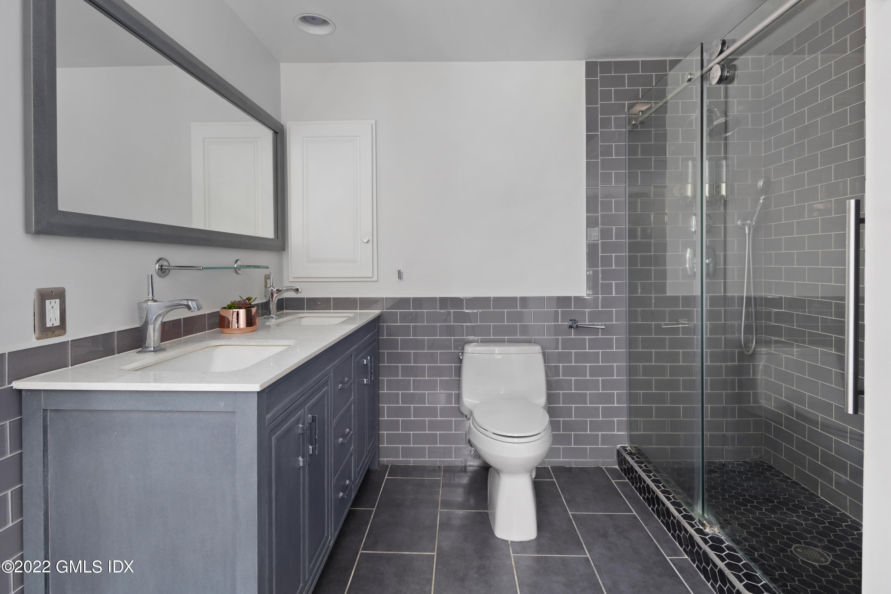 324 Haviland Road Stamford, CT 06903 - Photo 18 of 40 a bathroom with a sink toilet a mirror and shower