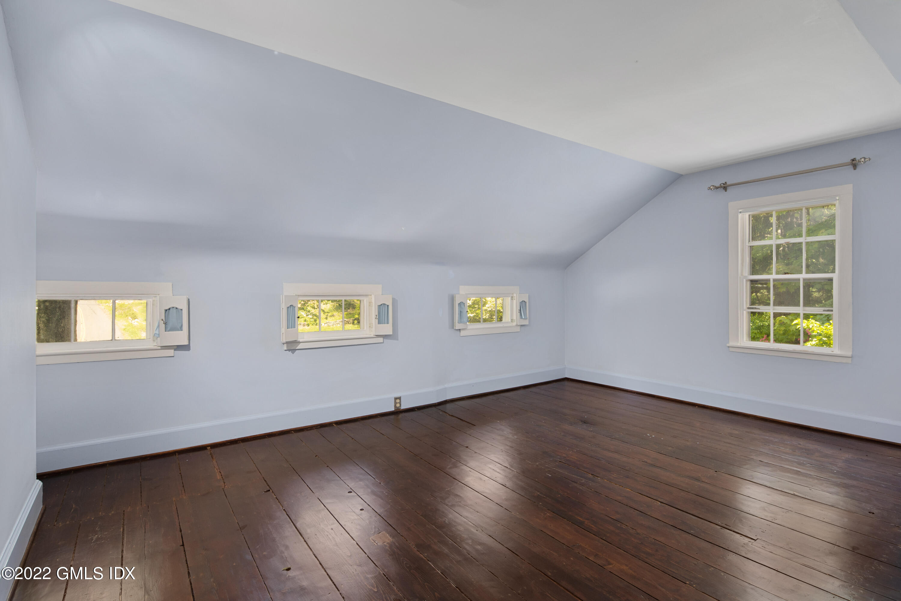 324 Haviland Road Stamford, CT 06903 - Photo 20 of 40 a view of an empty room with wooden floor and a window