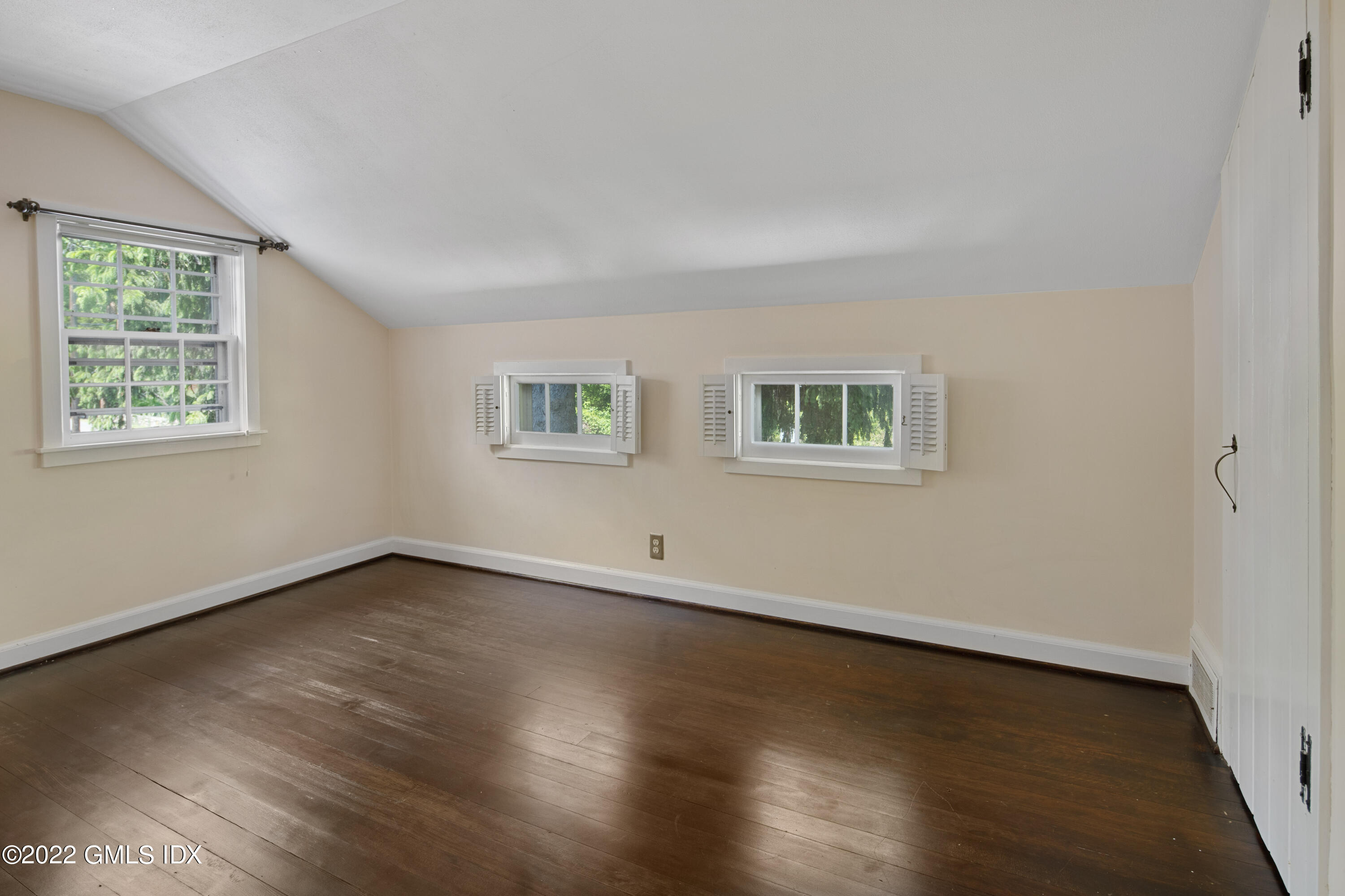 324 Haviland Road Stamford, CT 06903 - Photo 21 of 40 a view of an empty room with wooden floor and a window