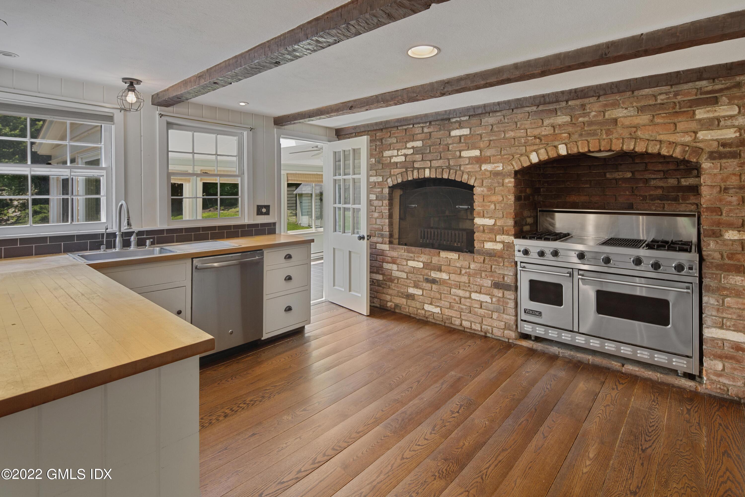 324 Haviland Road Stamford, CT 06903 - Photo 3 of 40 a kitchen with stainless steel appliances a stove sink and microwave