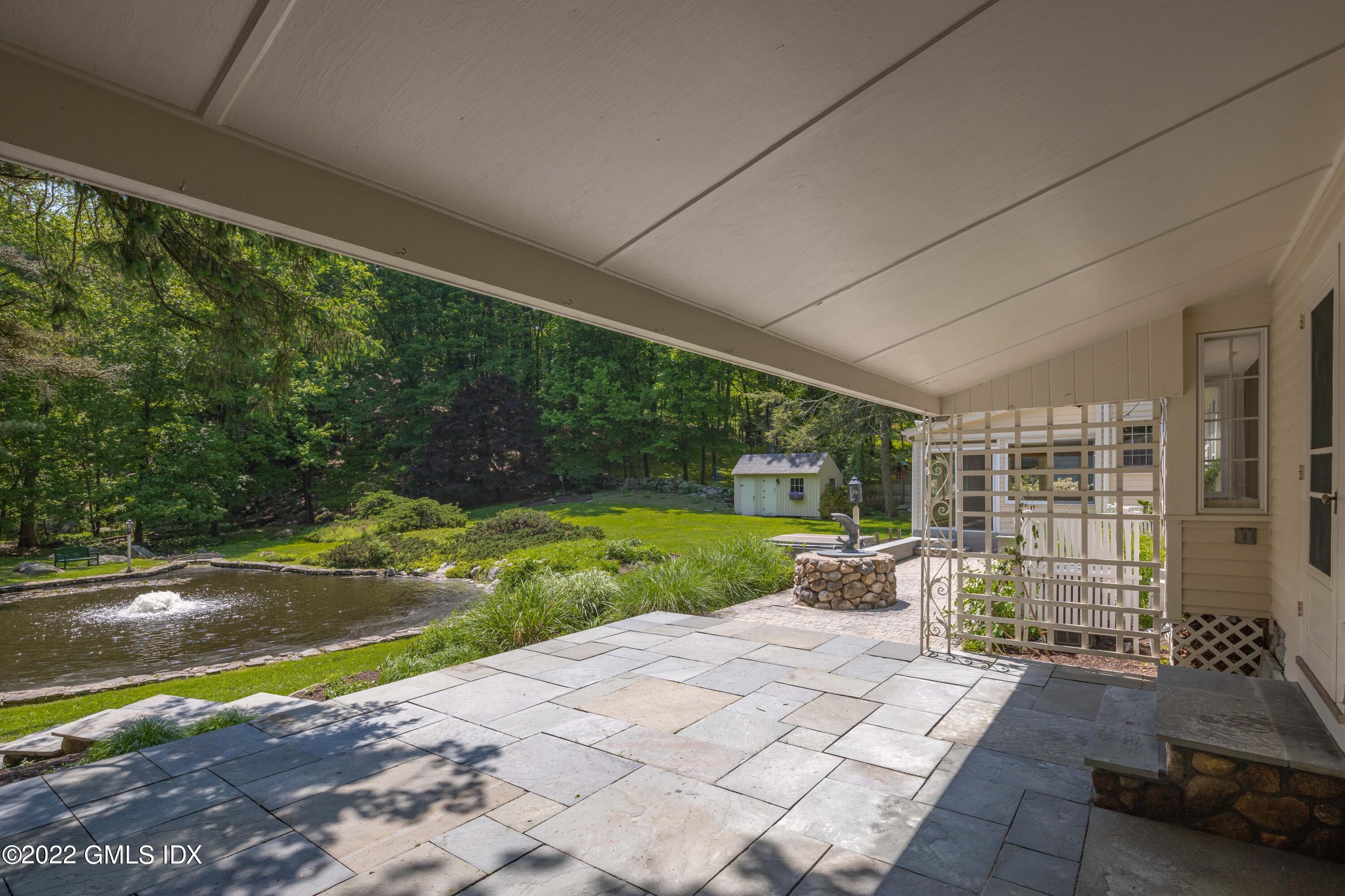 324 Haviland Road Stamford, CT 06903 - Photo 31 of 40 a view of a patio with couches plants and big yard