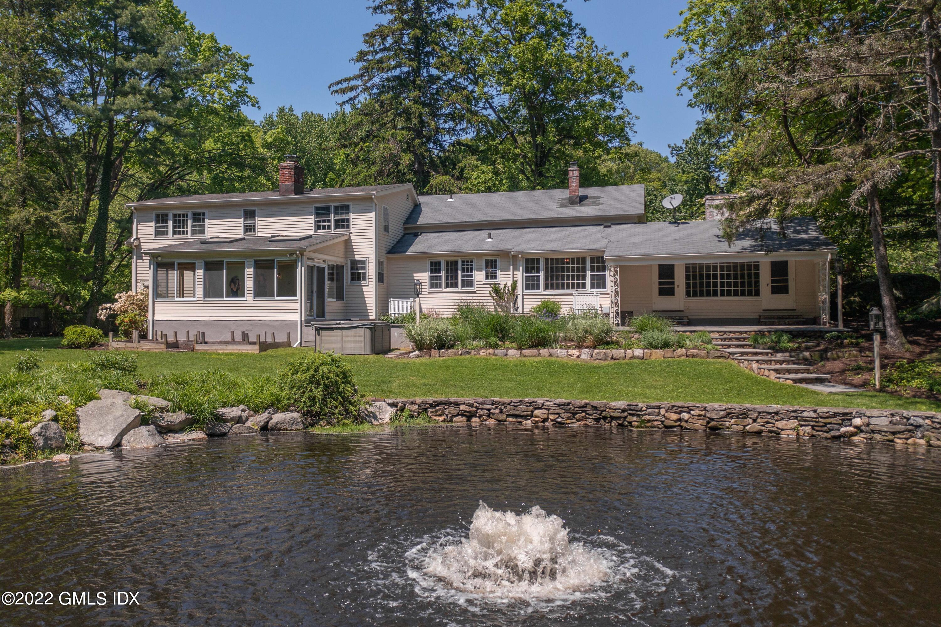 324 Haviland Road Stamford, CT 06903 - Photo 34 of 40 a front view of a house with a yard with swimming pool and outdoor seating