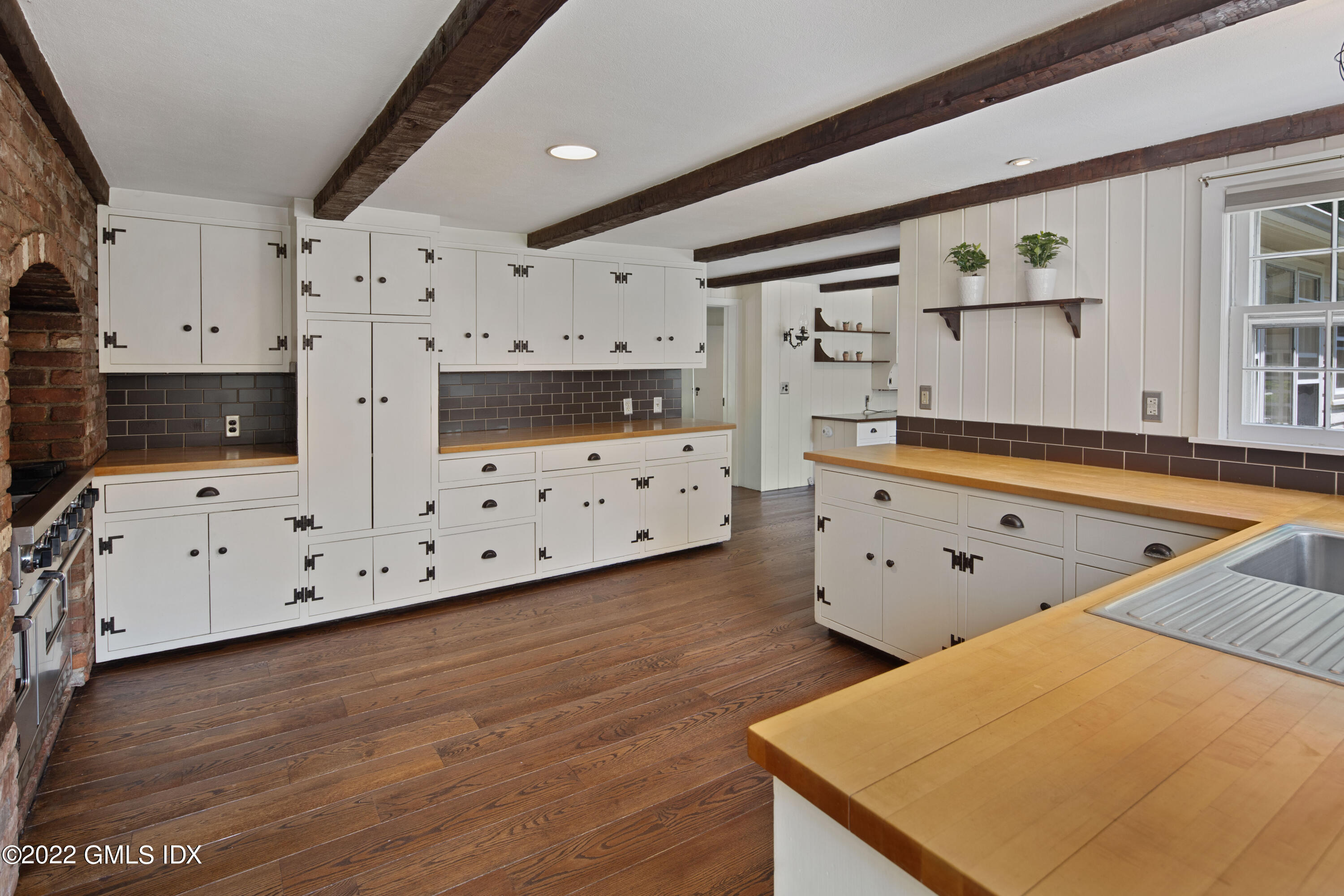 324 Haviland Road Stamford, CT 06903 - Photo 5 of 40 a kitchen with cabinets appliances wooden floor and a window