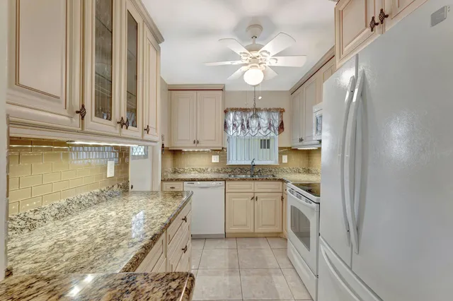 a kitchen with stainless steel appliances granite countertop a sink and cabinets