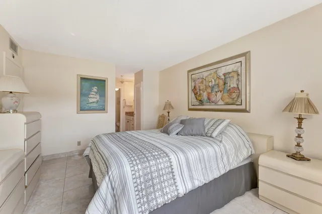 a bedroom with a bed and a painting on the wall