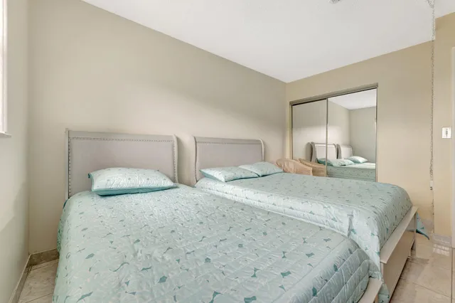 a bedroom with a bed and a mirror