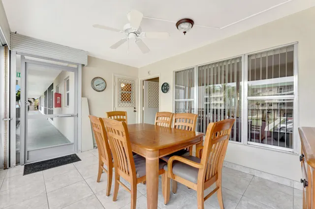 a view of a dining room with furniture and a large window