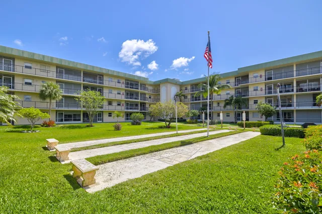a front view of a building with garden