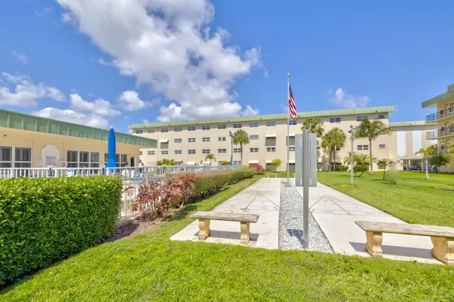 a view of a swimming pool of the house with a yard