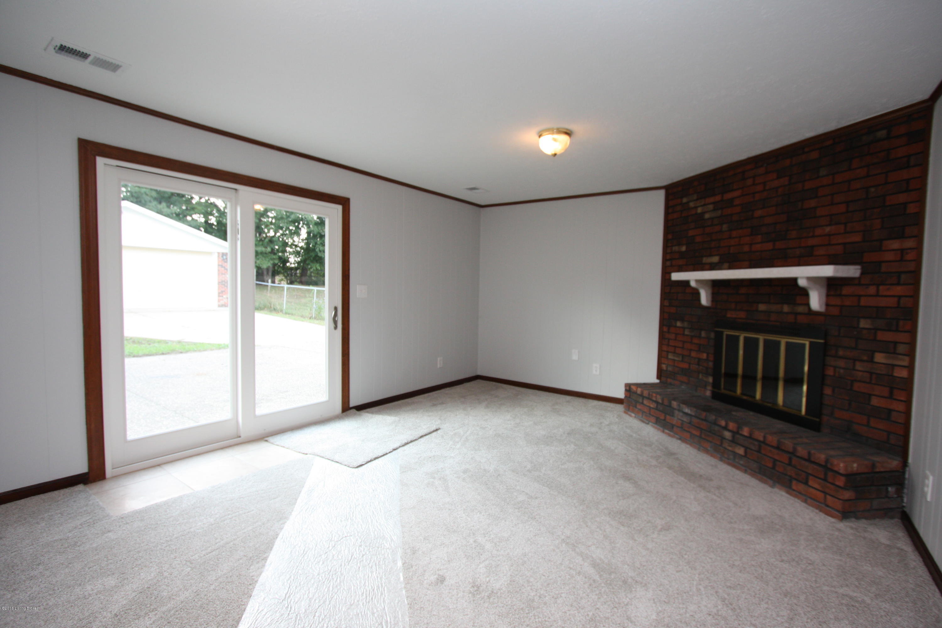 3712 Longview Road Jeffersontown, KY 40299 - Photo 22 of 35 Lower level family room has wood burning fireplace and walks out to patio.