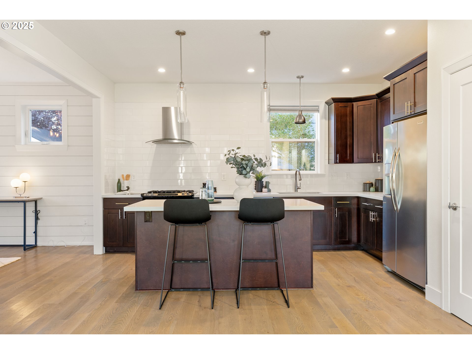 4735 Southeast Bush Street Portland, OR 97206 - Photo 11 of 47 a kitchen with stainless steel appliances kitchen island granite countertop a refrigerator a stove a sink dishwasher with a dining table and chairs