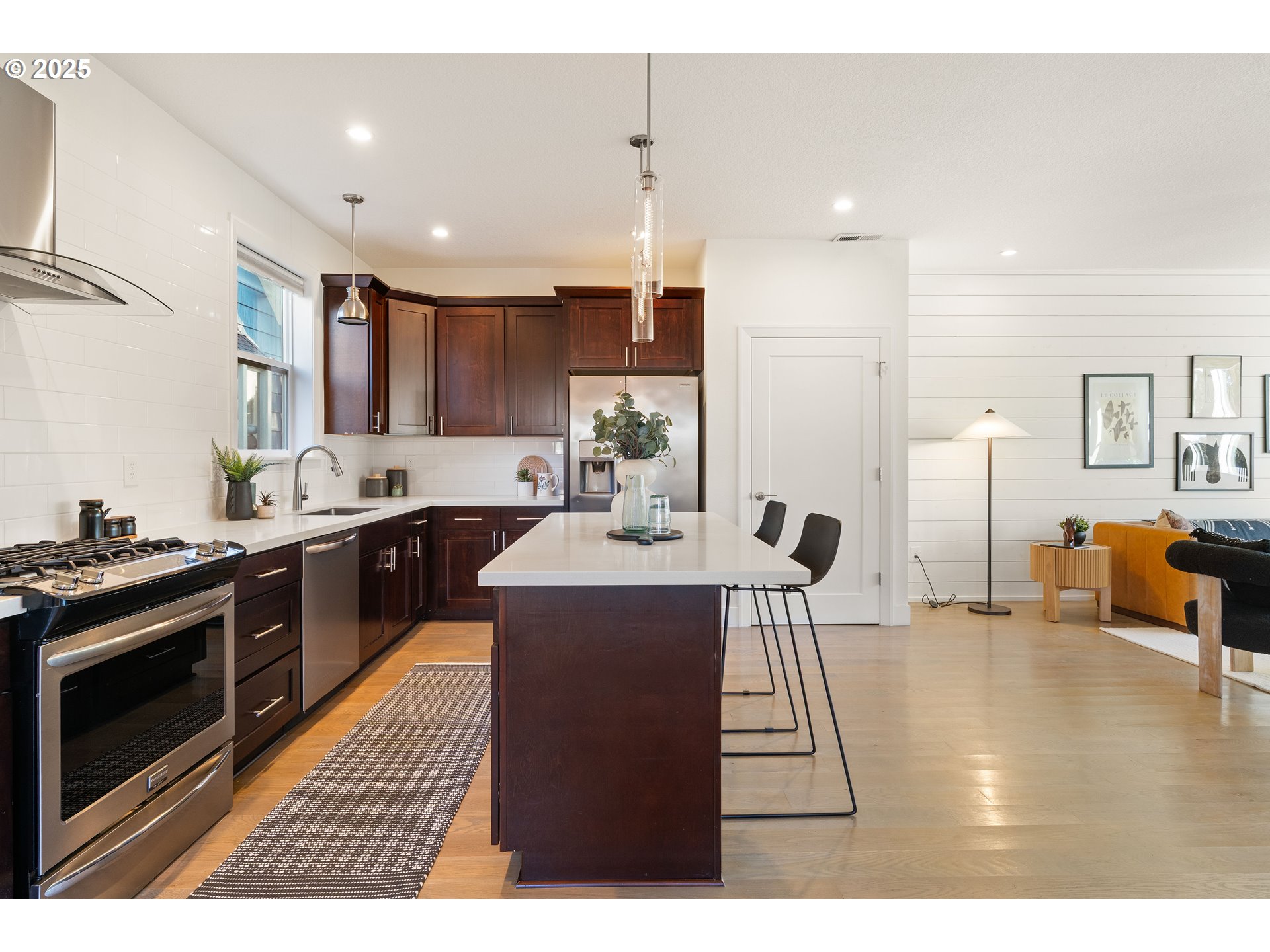 4735 Southeast Bush Street Portland, OR 97206 - Photo 12 of 47 a kitchen with stainless steel appliances kitchen island granite countertop a stove a sink a refrigerator and a cabinets