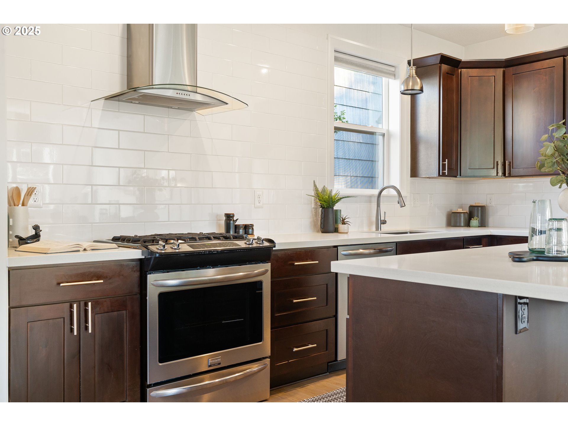 4735 Southeast Bush Street Portland, OR 97206 - Photo 14 of 47 a kitchen with stainless steel appliances a stove sink and cabinets