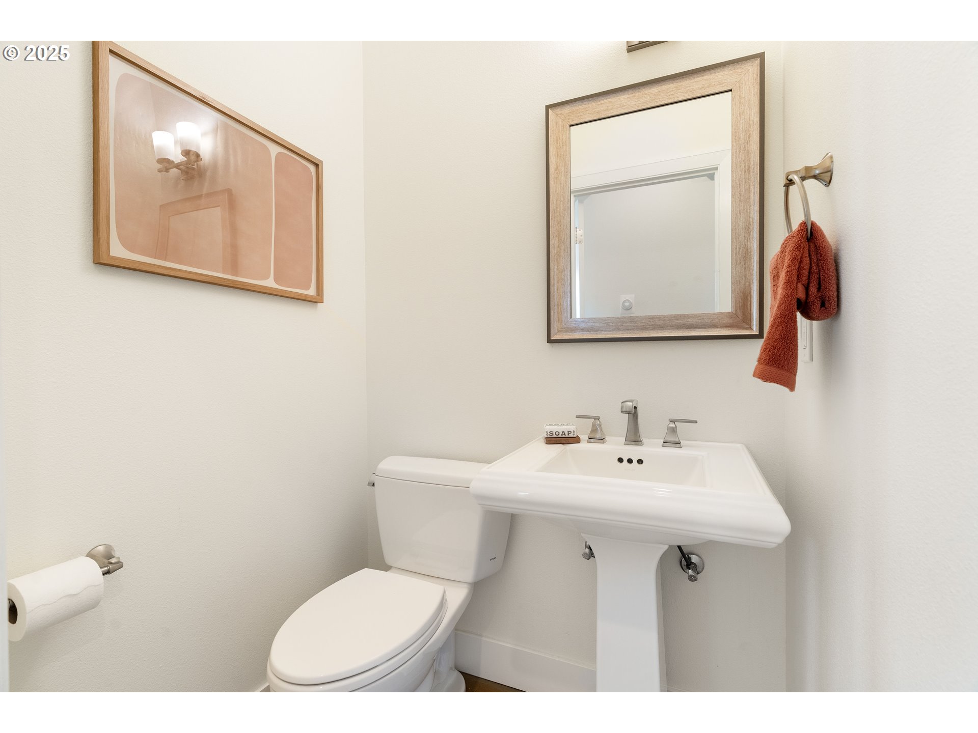 4735 Southeast Bush Street Portland, OR 97206 - Photo 19 of 47 a bathroom with a toilet sink and mirror