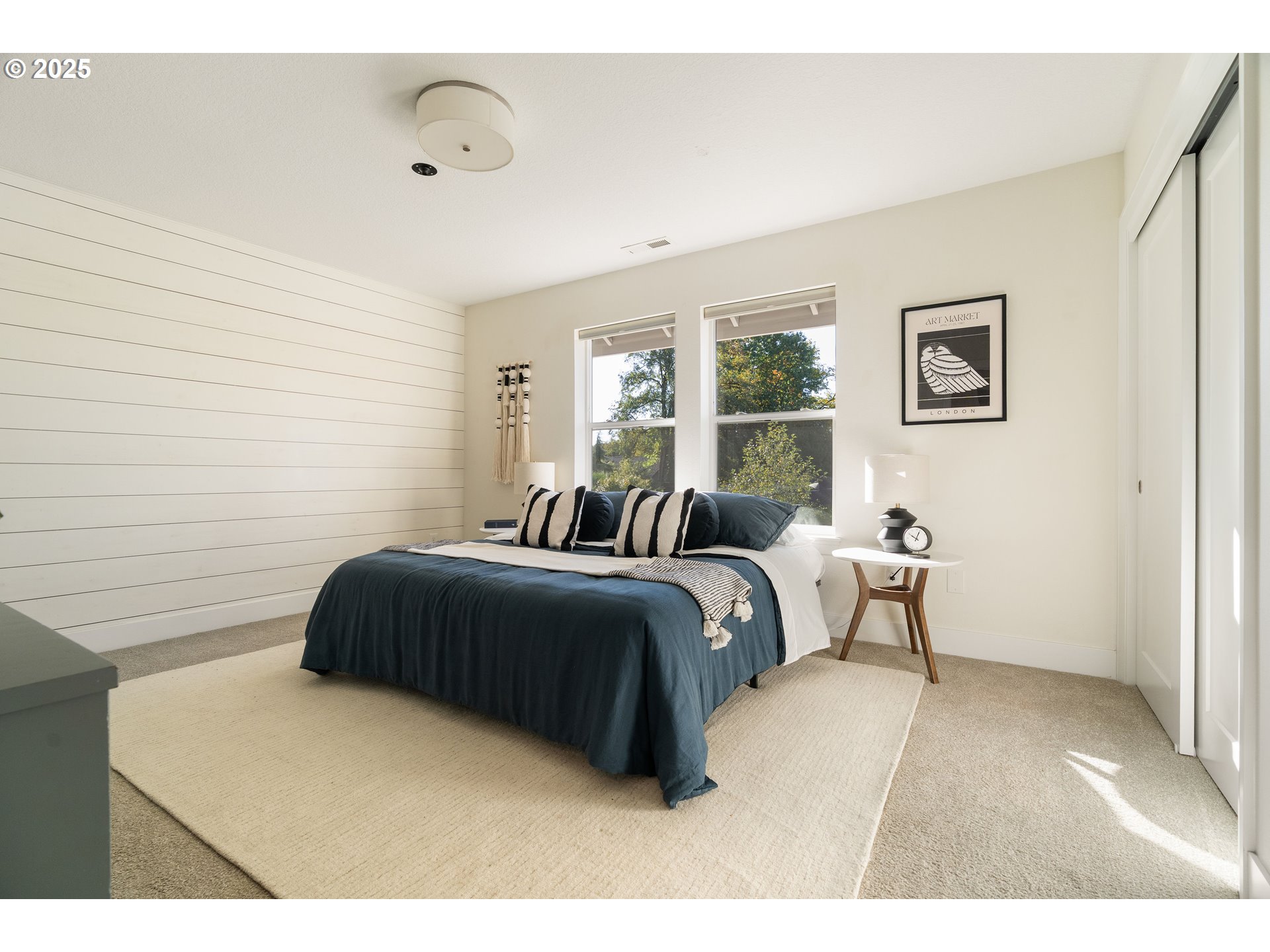 4735 Southeast Bush Street Portland, OR 97206 - Photo 20 of 47 a bedroom with a bed and wooden floor