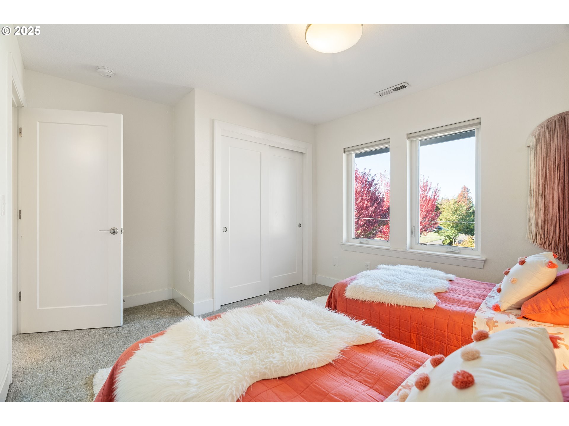 4735 Southeast Bush Street Portland, OR 97206 - Photo 30 of 47 a bedroom with a bed and a large window