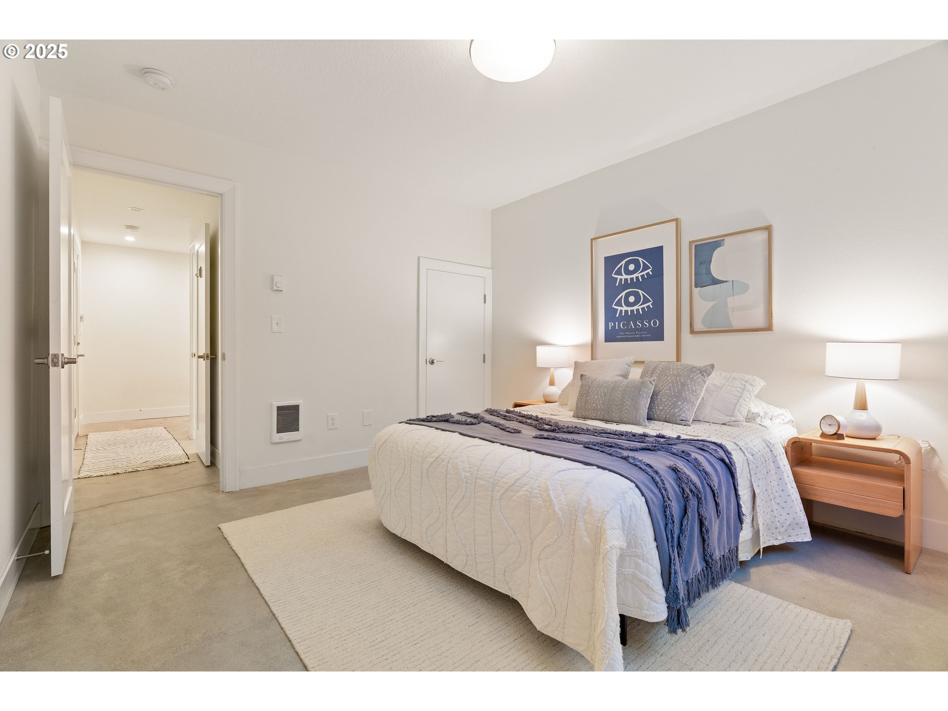 4735 Southeast Bush Street Portland, OR 97206 - Photo 36 of 47 a spacious bedroom with a bed and a painting