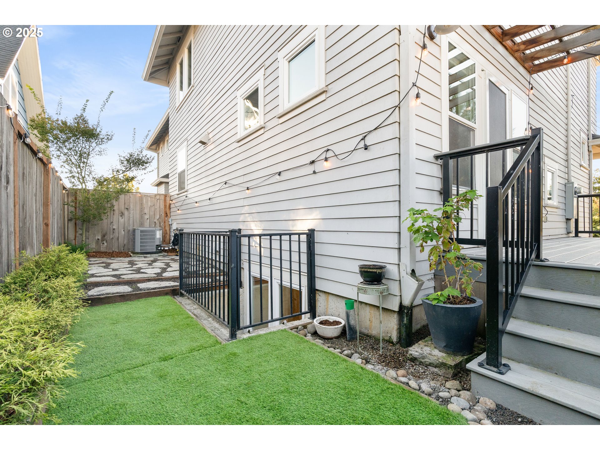 4735 Southeast Bush Street Portland, OR 97206 - Photo 39 of 47 a view of a house with backyard and a garden