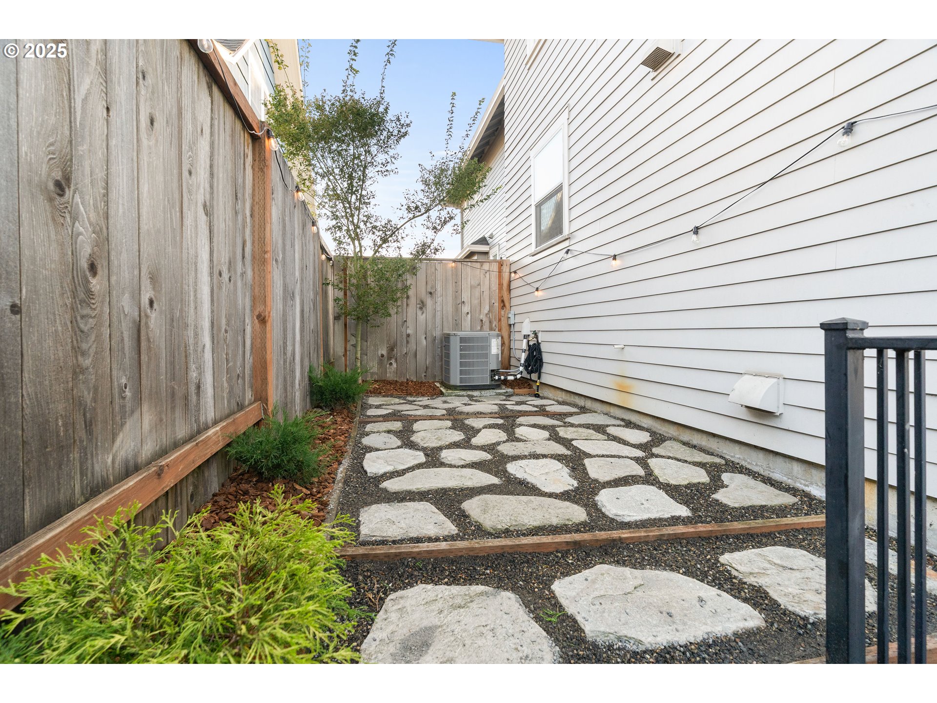 4735 Southeast Bush Street Portland, OR 97206 - Photo 41 of 47 a view of a backyard with plants and large tree
