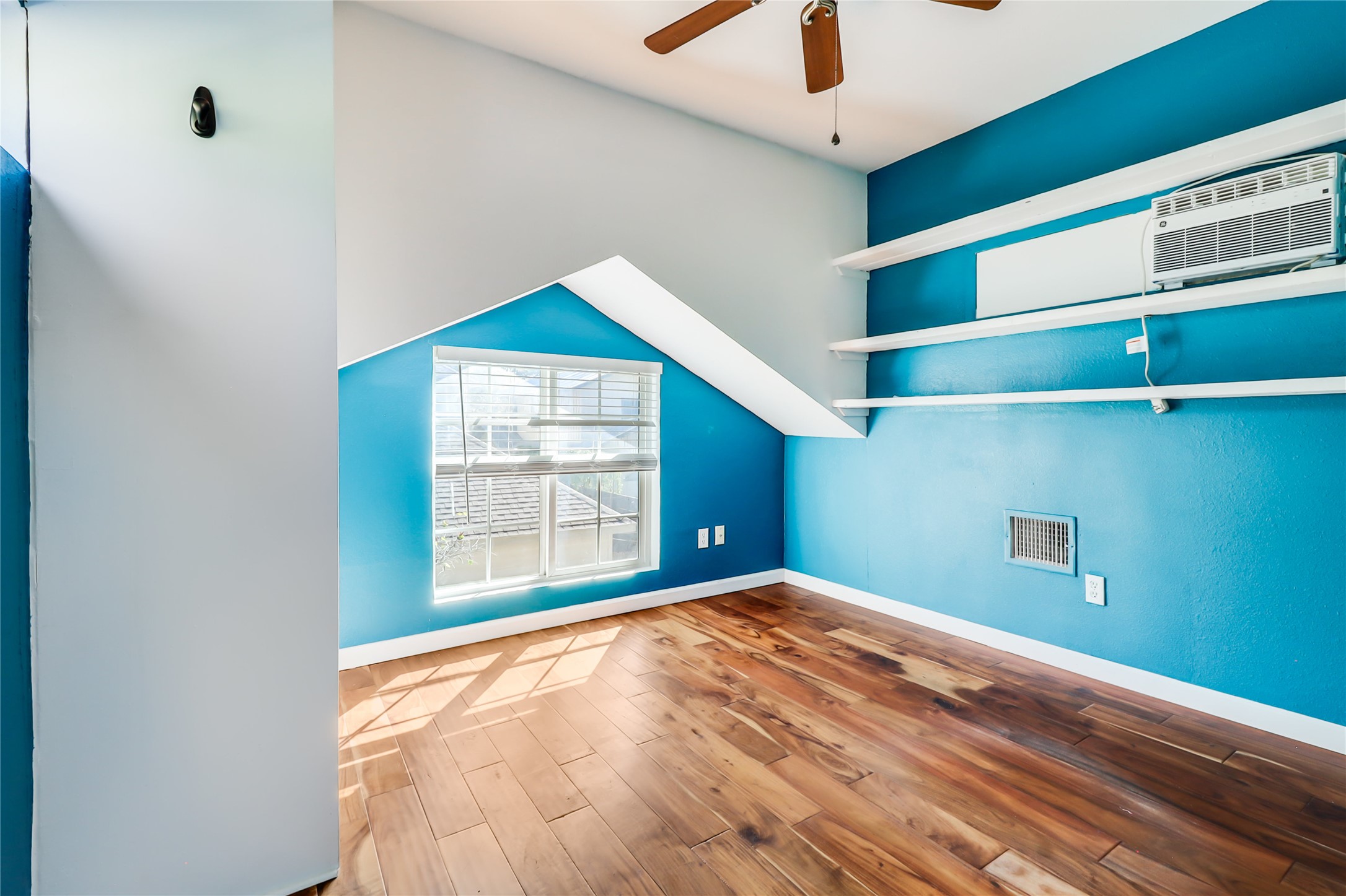 1105 West 43rd Street Austin, TX 78756 - Photo 15 of 22 a view of a room with a ceiling fan and a window