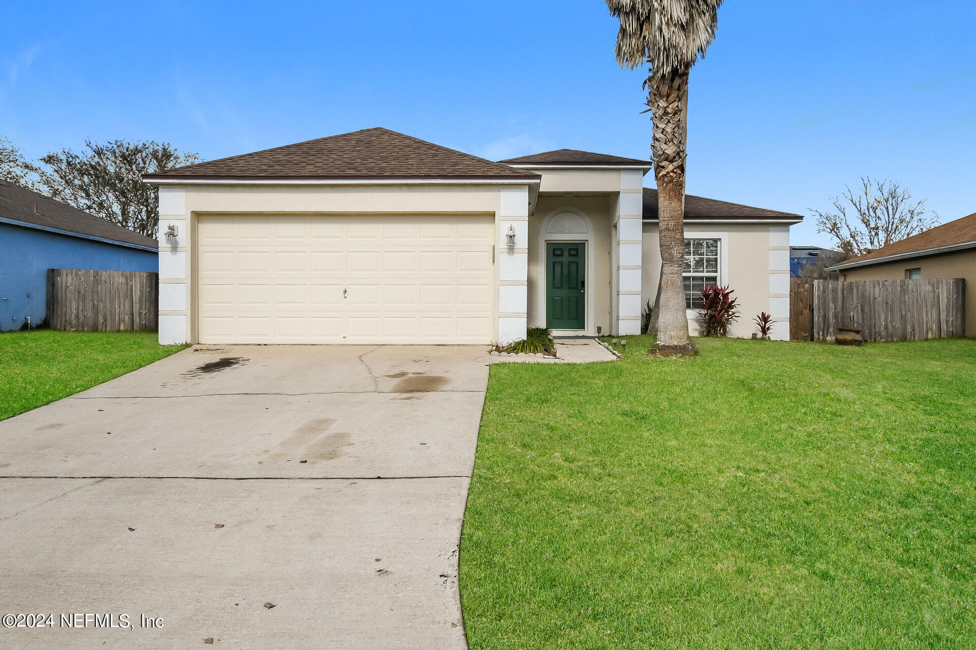 7351 Fox Grove Road Jacksonville, FL 32244 - Photo 1 of 17 a front view of a house with a yard and garage