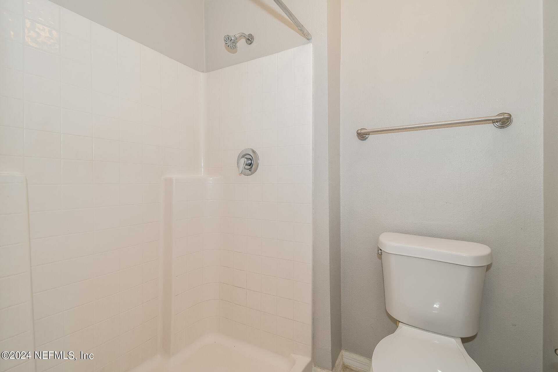 7351 Fox Grove Road Jacksonville, FL 32244 - Photo 13 of 17 a white toilet sitting next to a shower