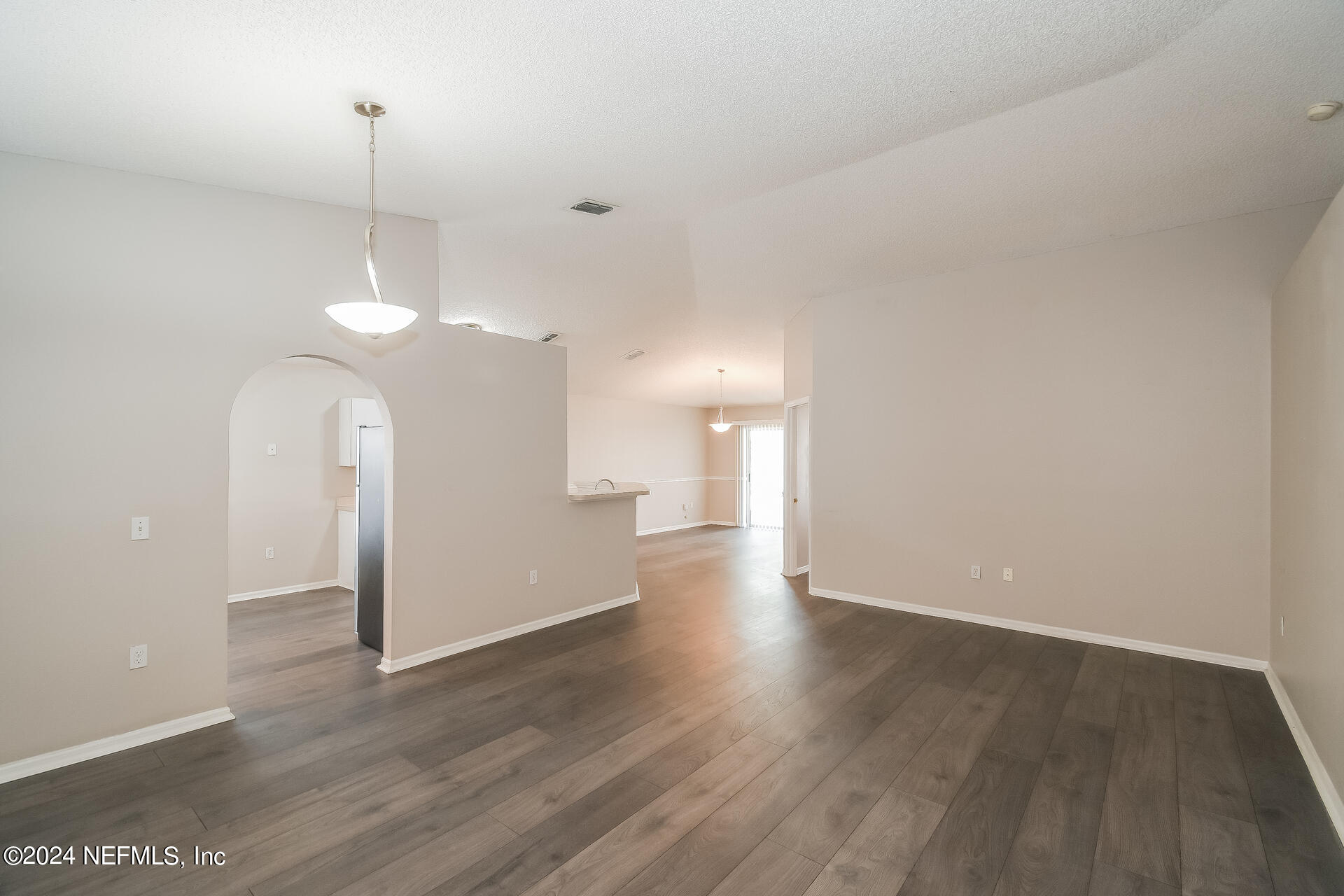 7351 Fox Grove Road Jacksonville, FL 32244 - Photo 4 of 17 a view of a room with wooden floor and a ceiling fan