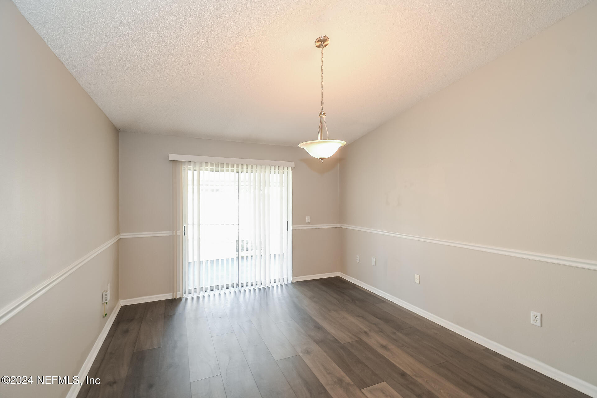 7351 Fox Grove Road Jacksonville, FL 32244 - Photo 6 of 17 a view of a room with wooden floor and windows
