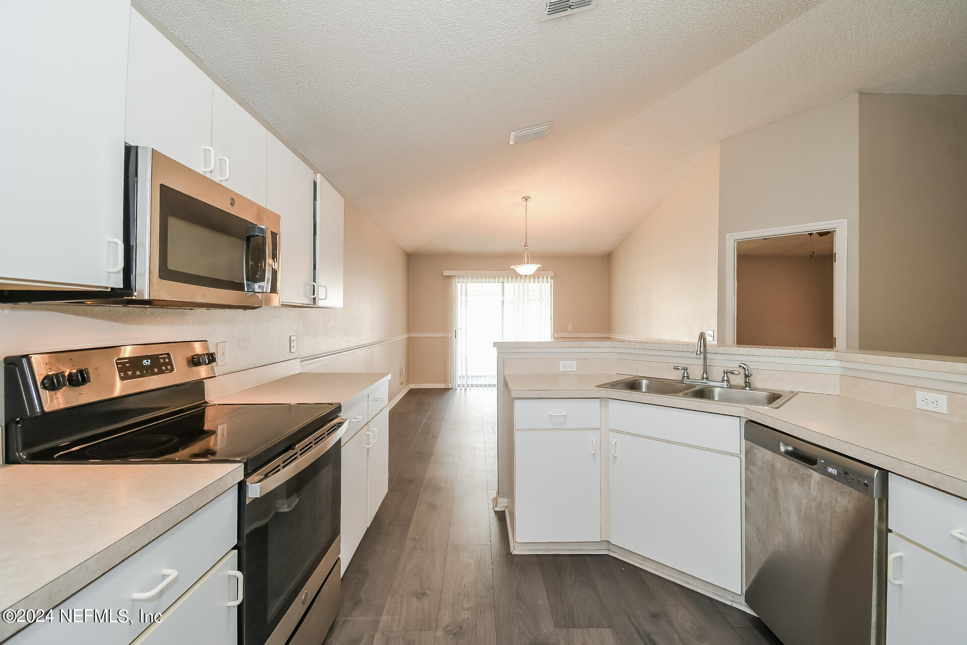 7351 Fox Grove Road Jacksonville, FL 32244 - Photo 7 of 17 a kitchen with a sink stove and microwave