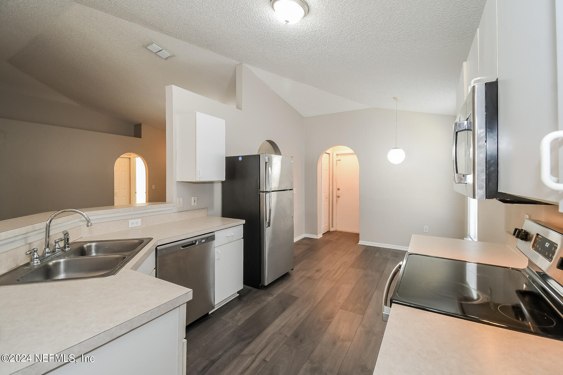 7351 Fox Grove Road Jacksonville, FL 32244 - Photo 8 of 17 a kitchen with stainless steel appliances granite countertop a sink stove and refrigerator