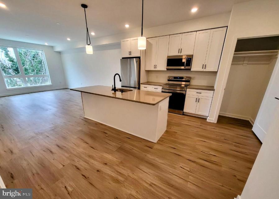 22 East Rittenhouse Street, Unit 3 Philadelphia, PA 19144 - Photo 1 of 13 a kitchen with stainless steel appliances a refrigerator microwave and stove