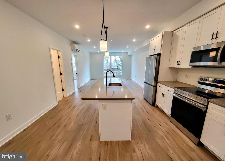 22 East Rittenhouse Street, Unit 3 Philadelphia, PA 19144 - Photo 2 of 13 a kitchen with stainless steel appliances a sink stove and refrigerator