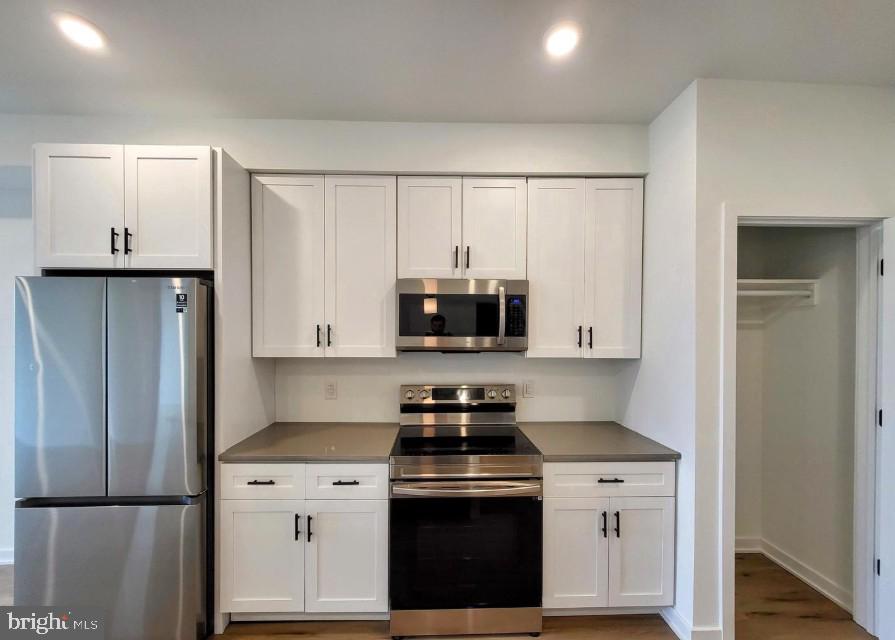 22 East Rittenhouse Street, Unit 3 Philadelphia, PA 19144 - Photo 3 of 13 a kitchen with white cabinets and stainless steel appliances