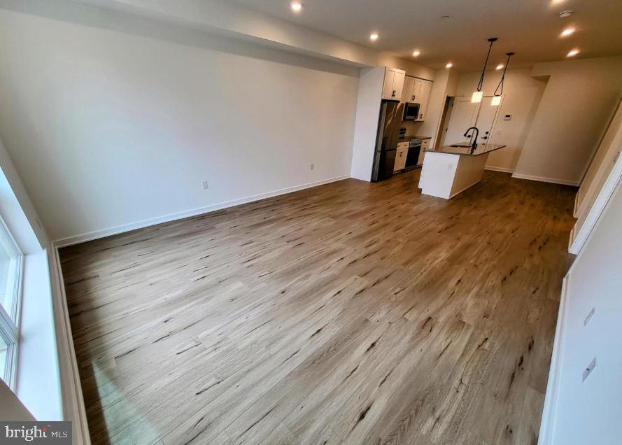 22 East Rittenhouse Street, Unit 3 Philadelphia, PA 19144 - Photo 5 of 13 a view of a room with wooden floor and a window