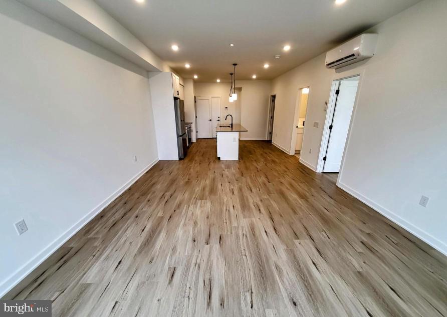 22 East Rittenhouse Street, Unit 3 Philadelphia, PA 19144 - Photo 6 of 13 a view of a big room with wooden floor and staircase