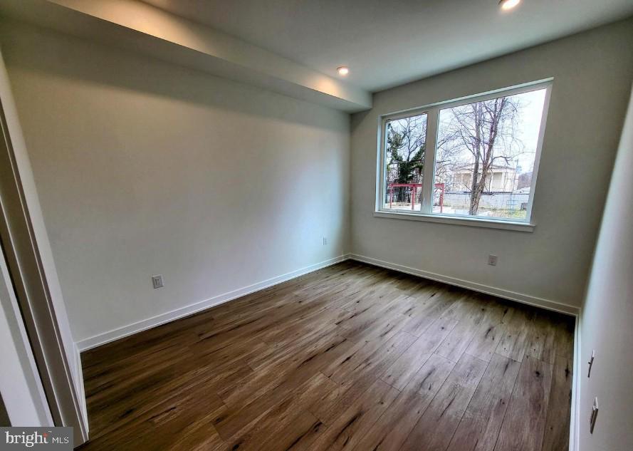 22 East Rittenhouse Street, Unit 3 Philadelphia, PA 19144 - Photo 8 of 13 an empty room with wooden floor and windows